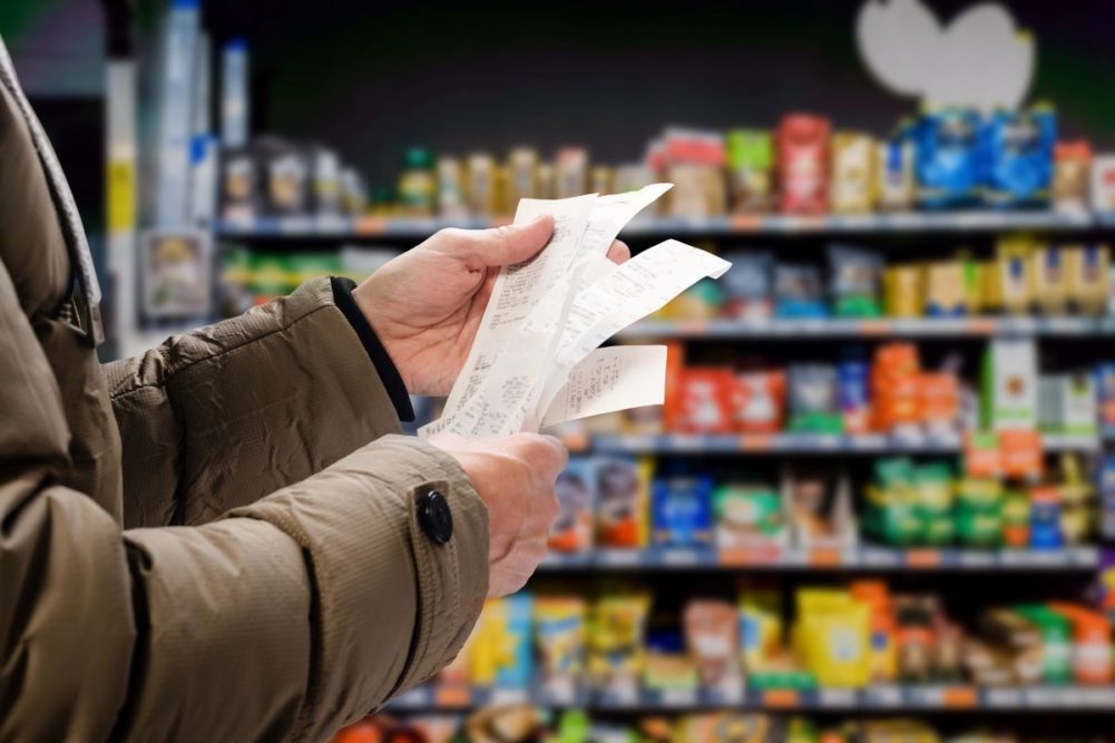 A consumer examining a grocery store reciept